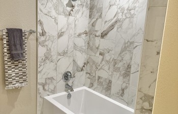 Renovated Bathtub and shower with Tile in the Bathroom of Overton Park - Fort Worth - Whole House transformation by Stanton & Company